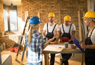 Bauherrin im Gespräch im Bauarbeitern Bauherrin im Gespräch im Bauarbeitern